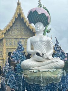 Chiang Rai One Day tour featuring the majestic Buddha statue inside the Blue Temple with stunning blue and gold details